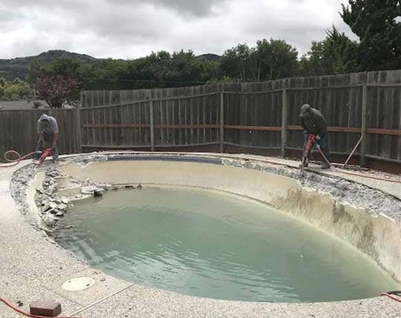 two contractors working on a pool demolition