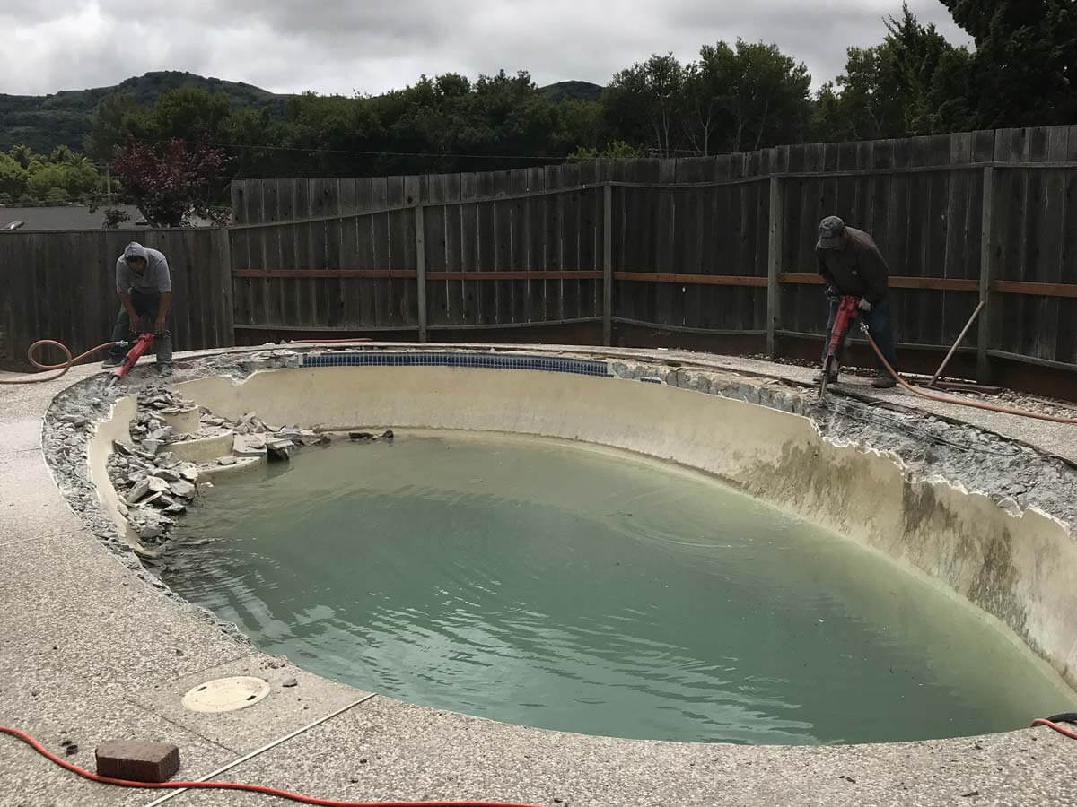 two of our contractors are removing the sides of the swimming pool